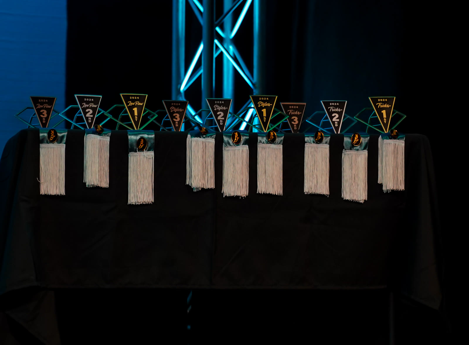 Dynasty 2024 trophies lined up on stage